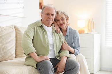 Photo of Lovely senior couple on sofa at home