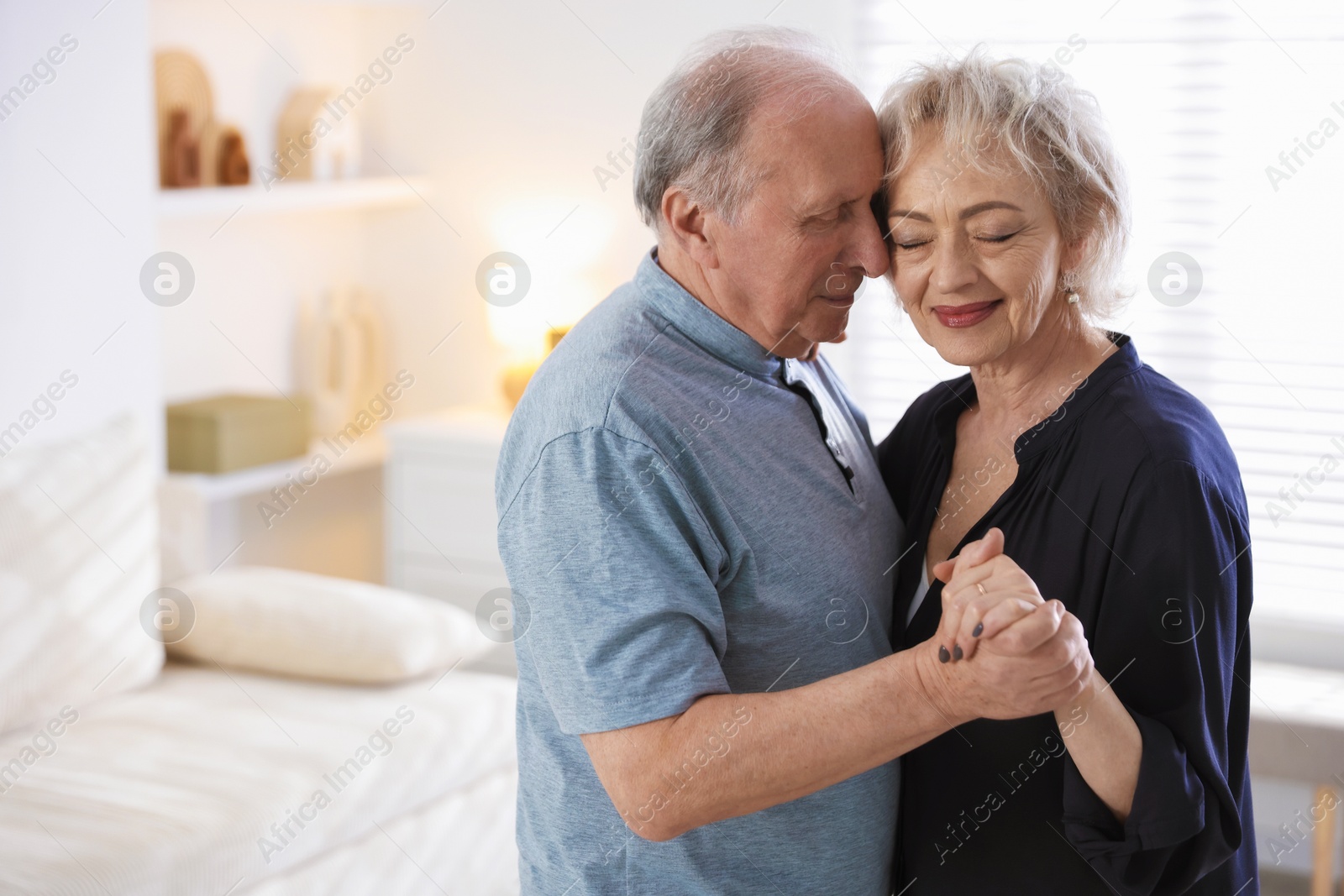Lovely senior couple at home, space for text Photo of Lovely senior couple at home, space for text