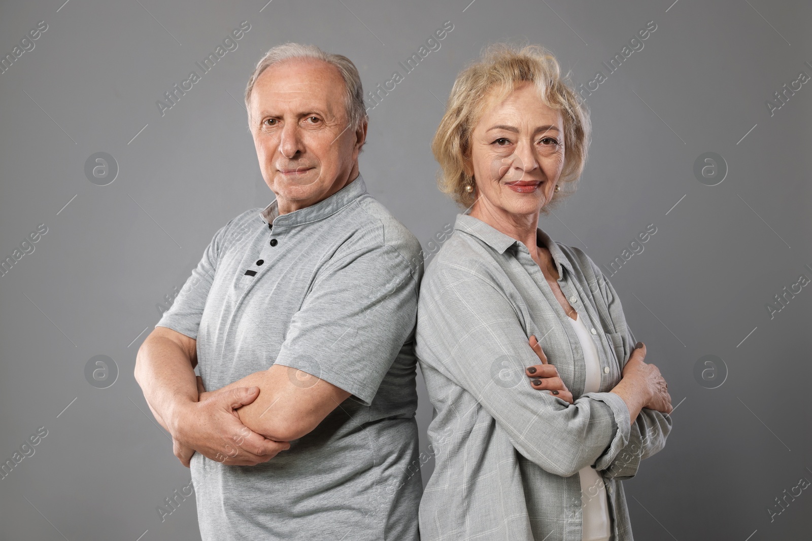 Portrait of lovely senior couple on grey background Photo of Portrait of lovely senior couple on grey background