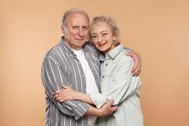 Photo of Portrait of lovely senior couple on beige background