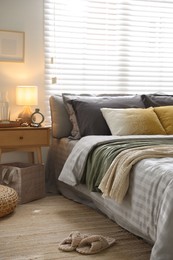 Photo of Comfortable bed with soft linens and blankets in room. Home textile