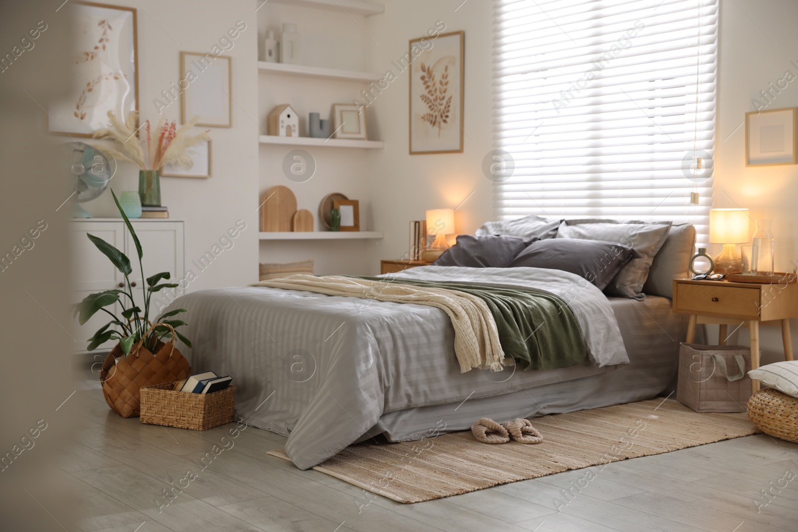 Comfortable bed with soft linens and blankets in room. Home textile Photo of Comfortable bed with soft linens and blankets in room. Home textile