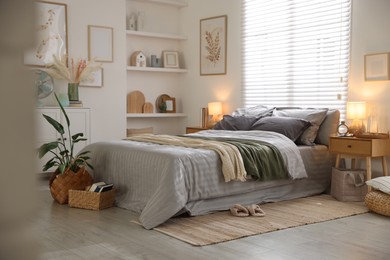 Photo of Comfortable bed with soft linens and blankets in room. Home textile