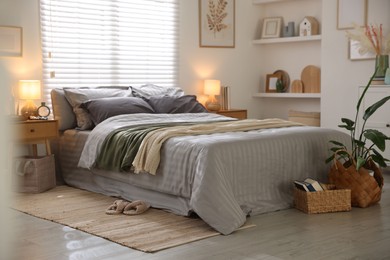 Photo of Comfortable bed with soft linens and blankets in room. Home textile