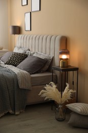 Photo of Comfortable bed with soft linens and decor in room. Home textile