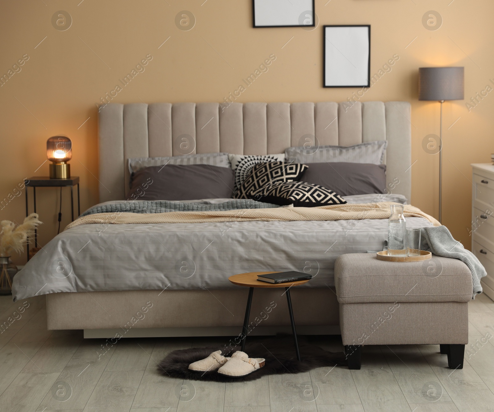 Comfortable bed with soft linens and blankets in room. Home textile Photo of Comfortable bed with soft linens and blankets in room. Home textile