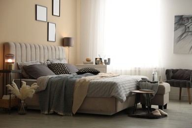 Photo of Comfortable bed with soft linens and blankets in room. Home textile
