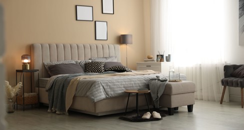 Photo of Comfortable bed with soft linens and blankets in room. Home textile