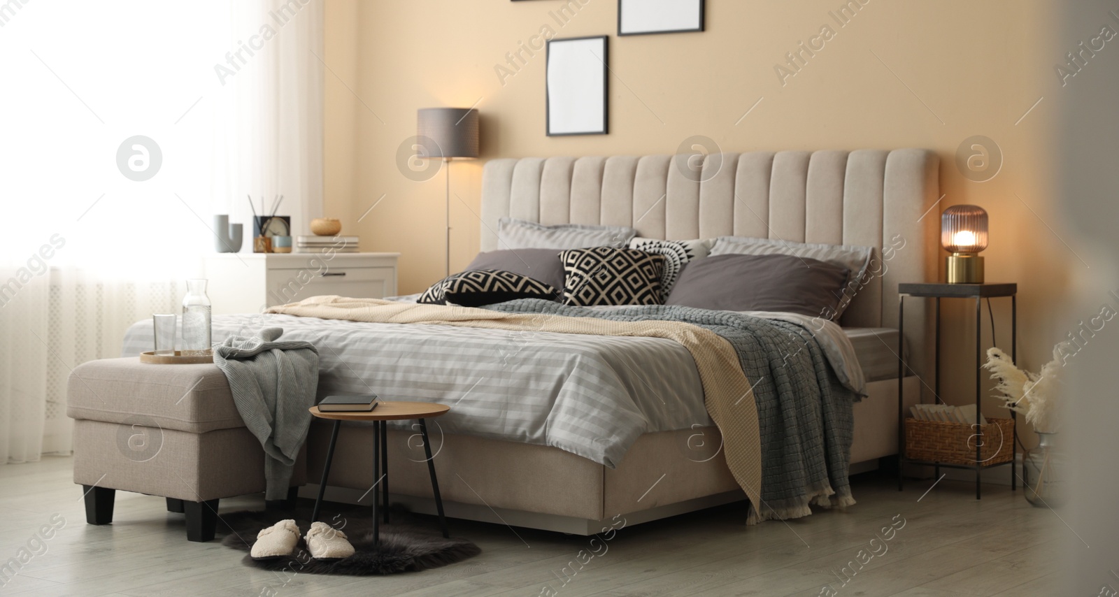 Comfortable bed with soft linens and blankets in room. Home textile Photo of Comfortable bed with soft linens and blankets in room. Home textile