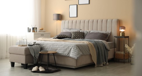 Photo of Comfortable bed with soft linens and blankets in room. Home textile