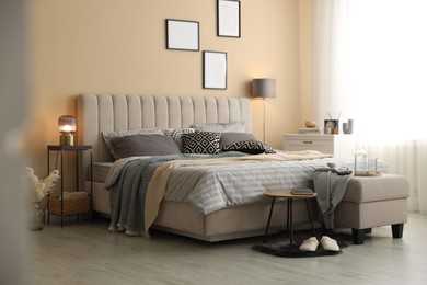 Photo of Comfortable bed with soft linens and blankets in room. Home textile