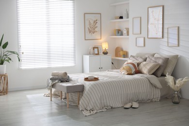 Photo of Comfortable bed with soft linens in room. Home textile