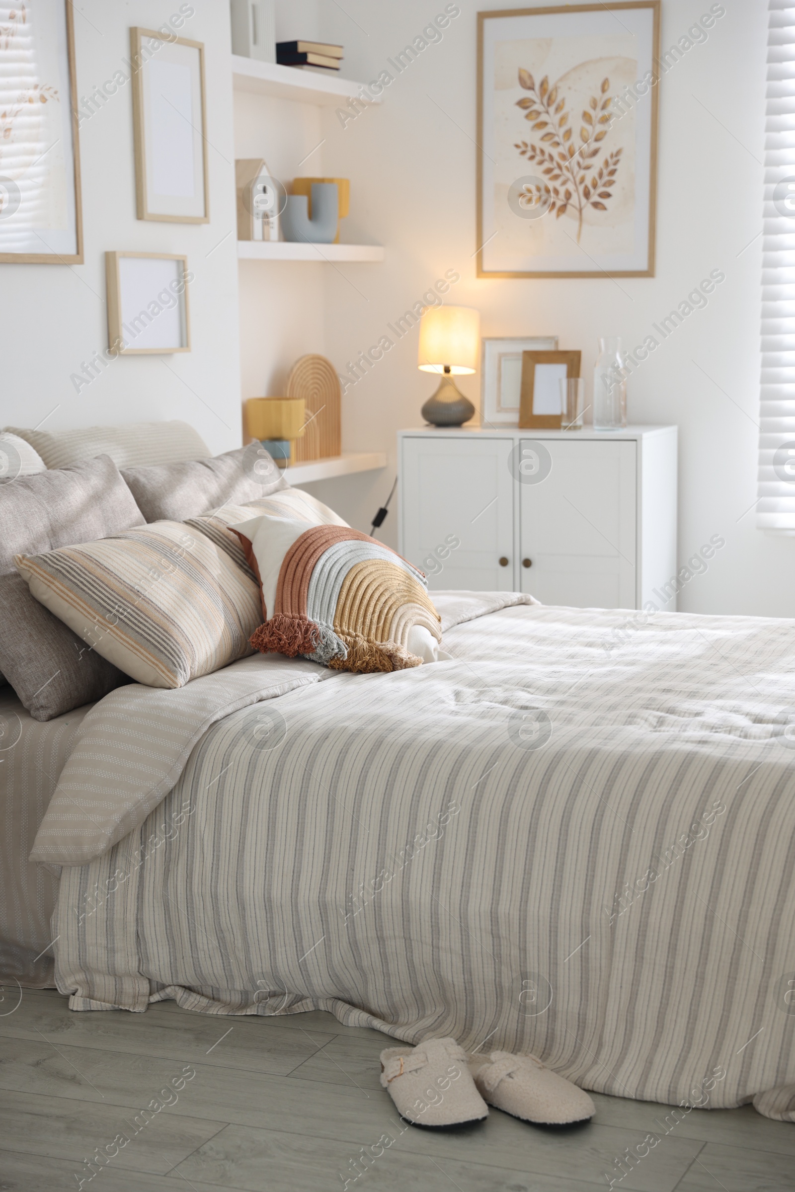 Comfortable bed with soft linens in room. Home textile Photo of Comfortable bed with soft linens in room. Home textile