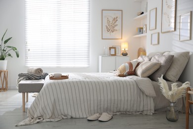 Photo of Comfortable bed with soft linens in room. Home textile
