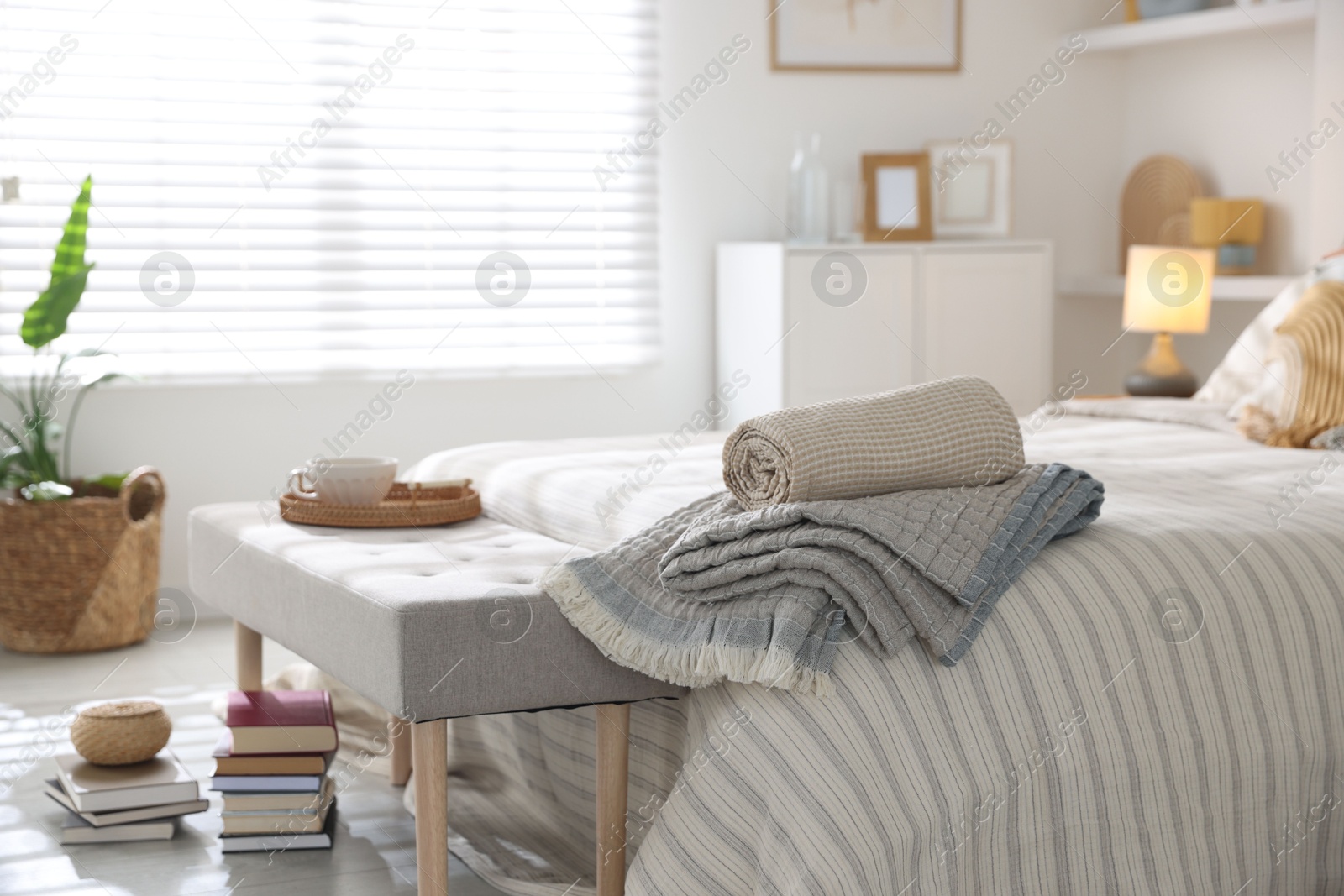 Comfortable bed with soft linens in room. Home textile Photo of Comfortable bed with soft linens in room. Home textile
