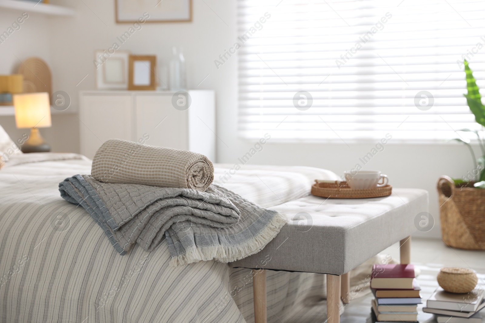 Comfortable bed with soft linens in room. Home textile Photo of Comfortable bed with soft linens in room. Home textile