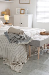 Photo of Comfortable bed with soft linens in room. Home textile
