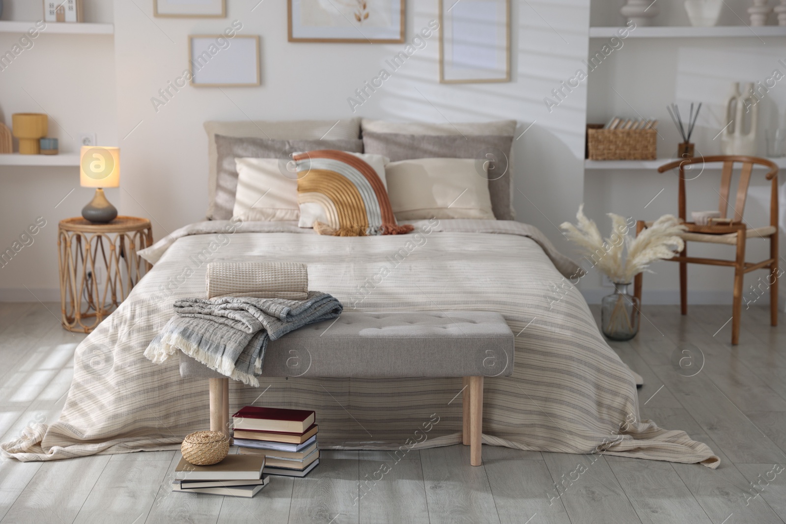 Comfortable bed with soft linens in room. Home textile Photo of Comfortable bed with soft linens in room. Home textile