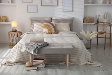 Photo of Comfortable bed with soft linens in room. Home textile