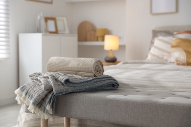 Photo of Comfortable bed with soft linens and blankets in room, closeup. Home textile