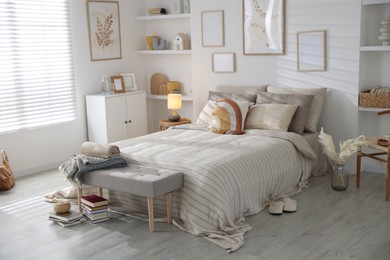 Photo of Comfortable bed with soft linens in room. Home textile