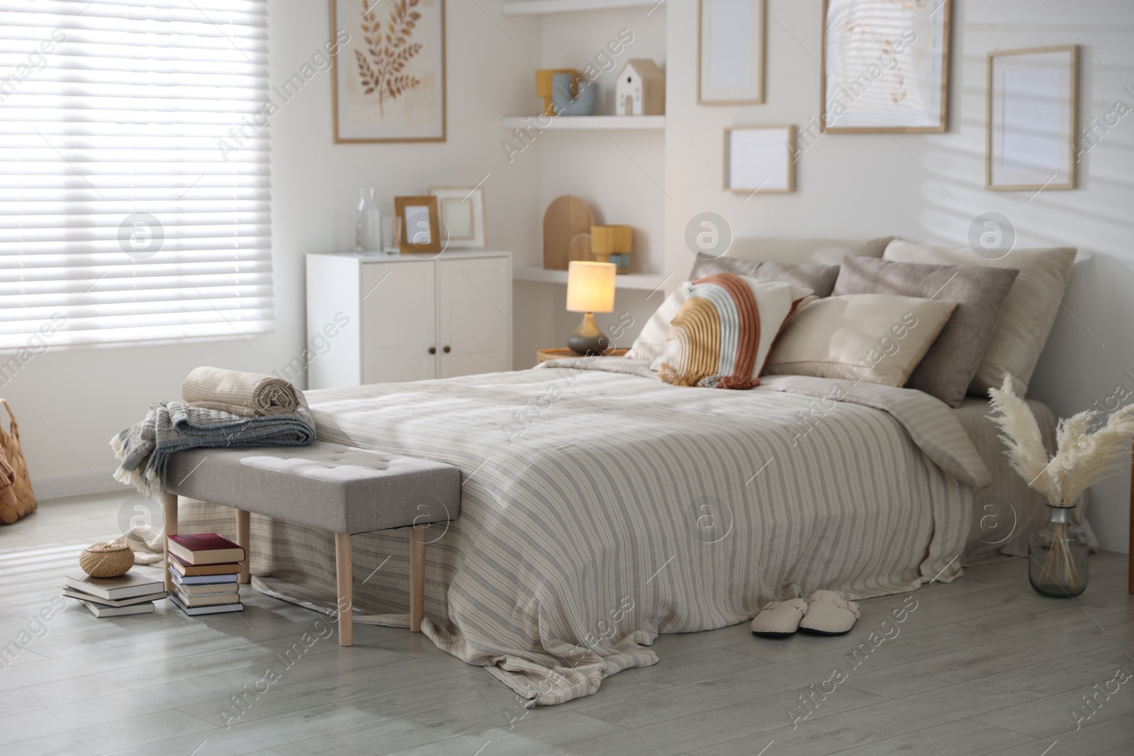 Comfortable bed with soft linens in room. Home textile Photo of Comfortable bed with soft linens in room. Home textile