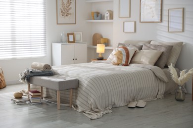 Photo of Comfortable bed with soft linens in room. Home textile