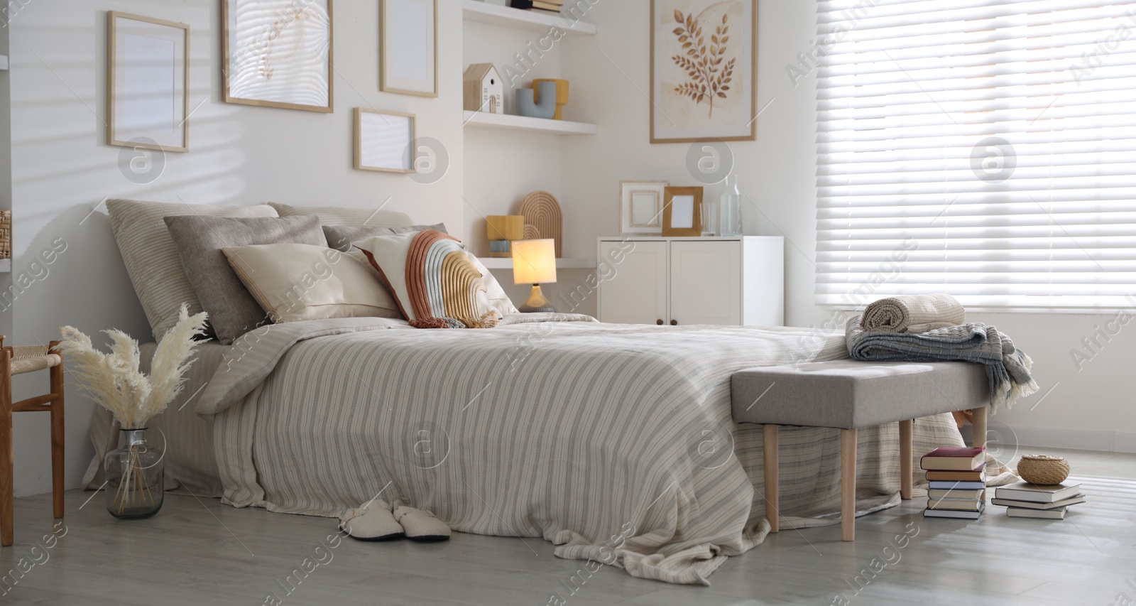 Comfortable bed with soft linens in room. Home textile Photo of Comfortable bed with soft linens in room. Home textile