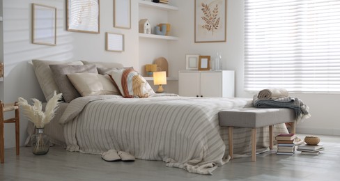 Photo of Comfortable bed with soft linens in room. Home textile