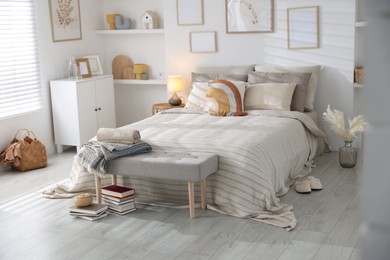 Photo of Comfortable bed with soft linens in room. Home textile