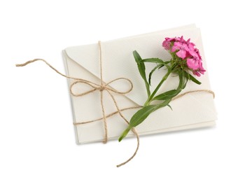 Photo of Stack of love letters and flower isolated on white, top view