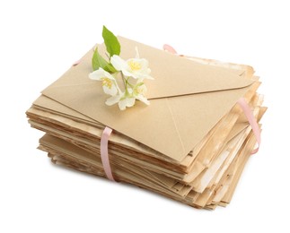 Photo of Stack of love letters and flowers isolated on white