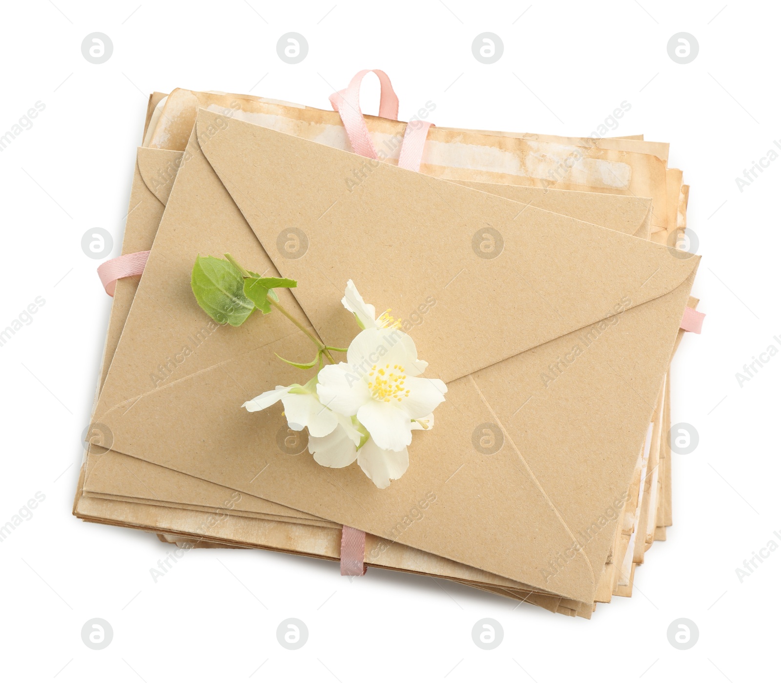 Stack of love letters and flowers isolated on white, top view Photo of Stack of love letters and flowers isolated on white, top view