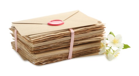 Photo of Stack of love letters and flowers isolated on white