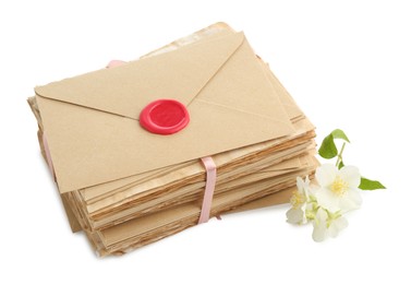 Photo of Stack of love letters and flowers isolated on white