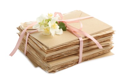 Photo of Stack of love letters and flowers isolated on white