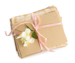 Photo of Stack of love letters and flowers isolated on white, top view