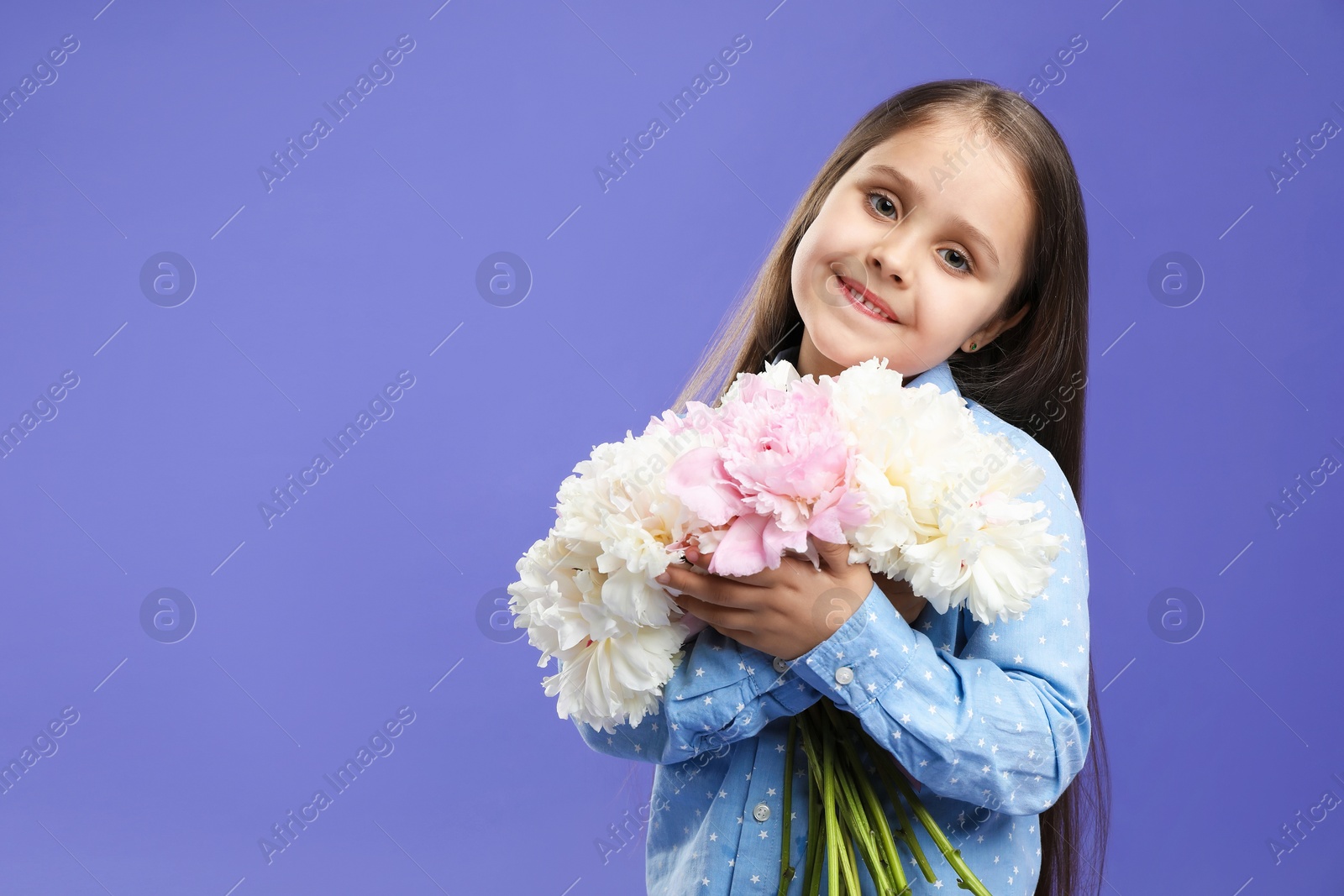 Cute little girl with bouquet of beautiful peonies on purple background, space for text Photo of Cute little girl with bouquet of beautiful peonies on purple background, space for text
