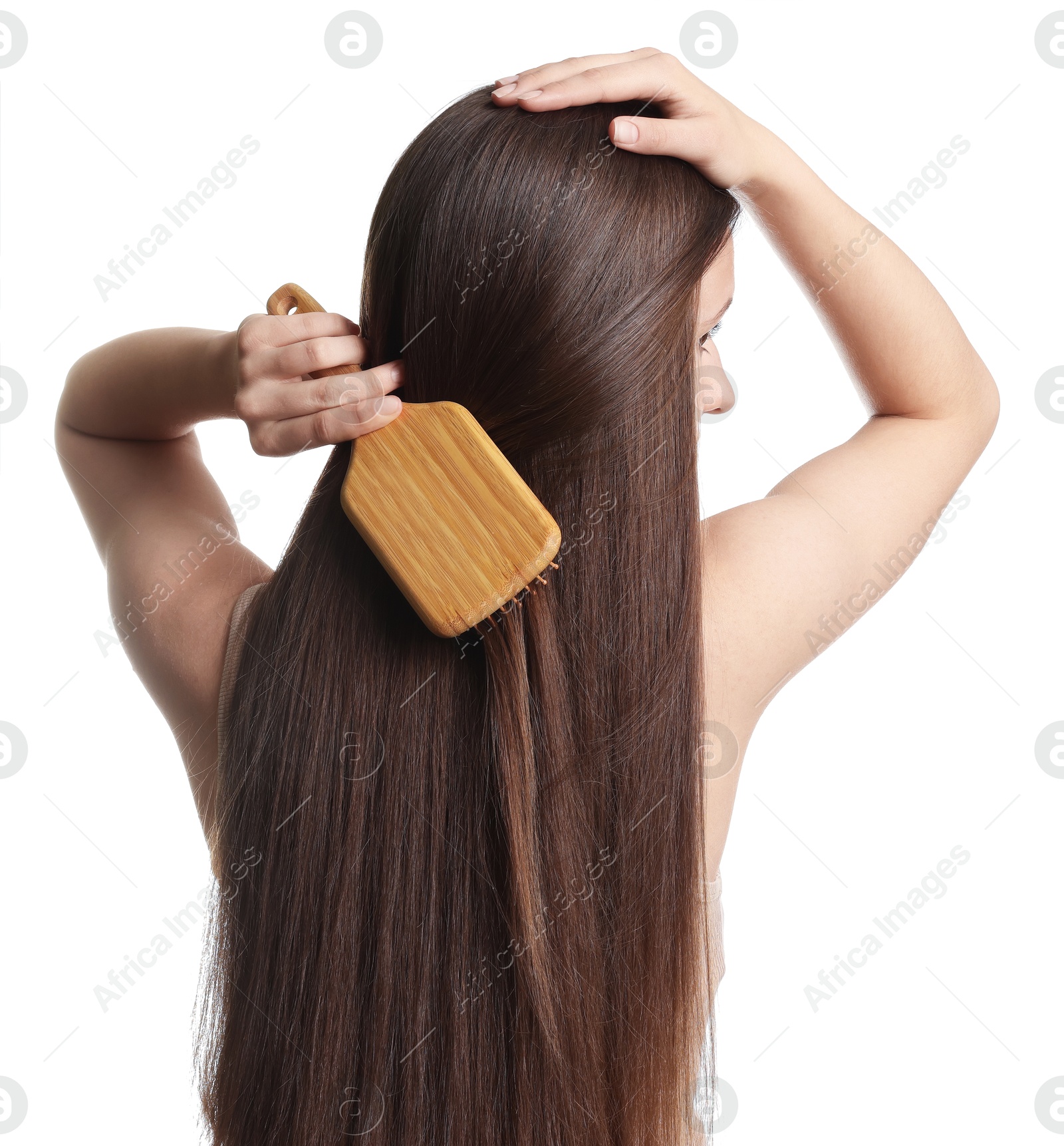 Teenage girl brushing her shiny hair on white background, back view Photo of Teenage girl brushing her shiny hair on white background, back view