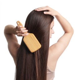 Photo of Teenage girl brushing her shiny hair on white background, back view