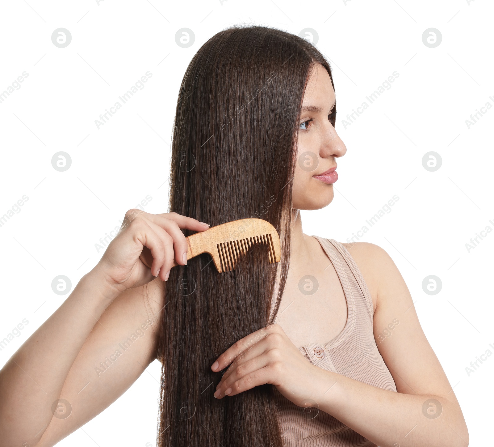 Beautiful teenage girl brushing her shiny hair on white background Photo of Beautiful teenage girl brushing her shiny hair on white background