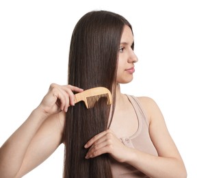 Photo of Beautiful teenage girl brushing her shiny hair on white background
