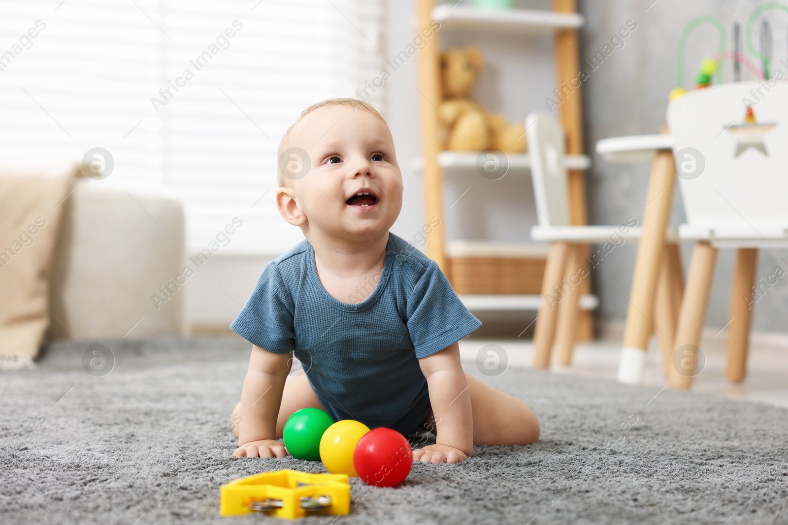 Cute little baby playing with toys in room Photo of Cute little baby playing with toys in room