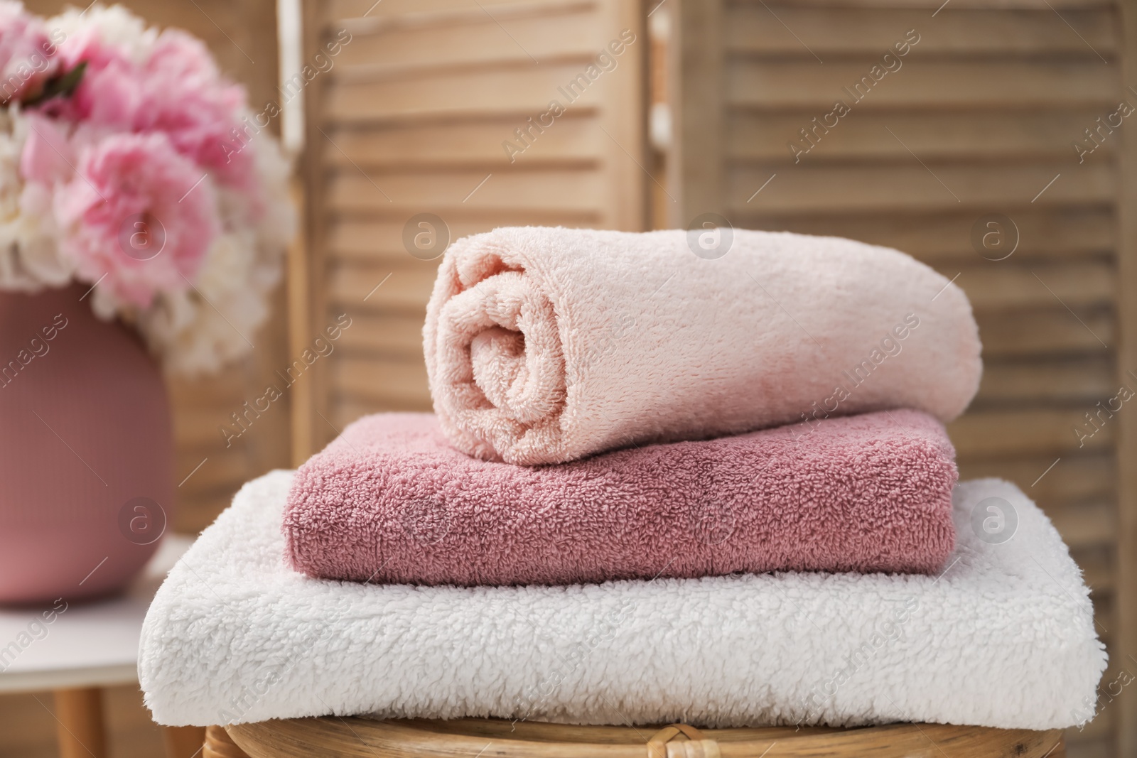 Stack of soft towels on table indoors, closeup Photo of Stack of soft towels on table indoors, closeup