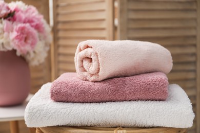 Photo of Stack of soft towels on table indoors, closeup