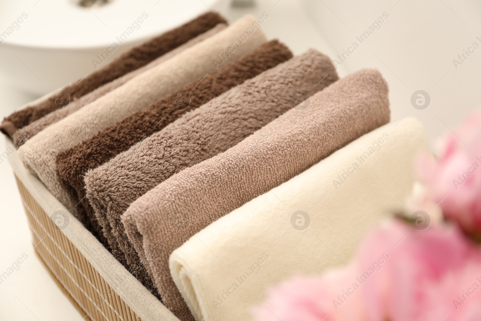Soft towels in storage basket indoors, closeup Photo of Soft towels in storage basket indoors, closeup