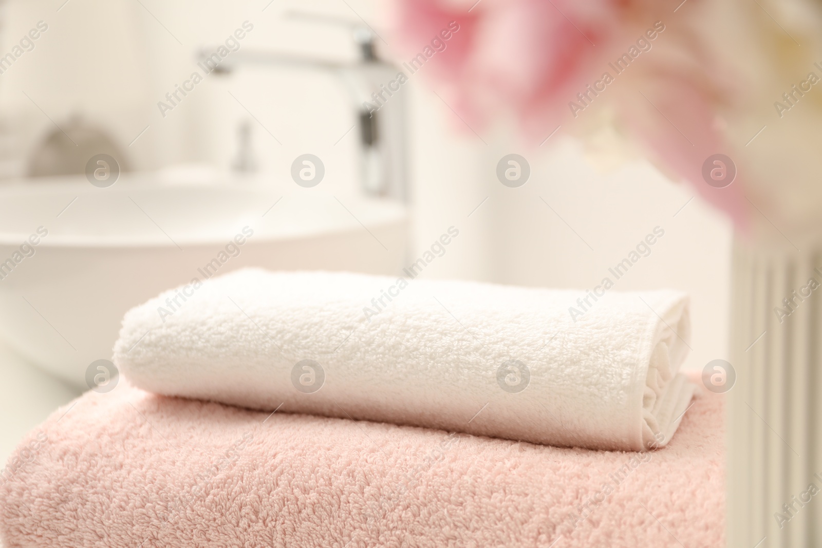 Stack of soft towels in bathroom, closeup Photo of Stack of soft towels in bathroom, closeup