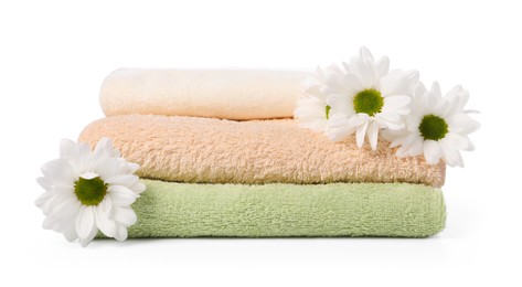 Photo of Soft towels and chrysanthemum flowers isolated on white