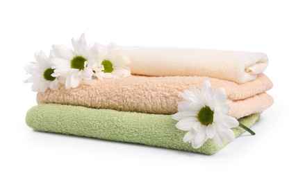 Photo of Soft towels and chrysanthemum flowers isolated on white