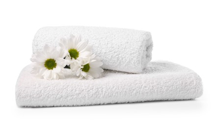 Photo of Soft towels and chrysanthemum flowers isolated on white